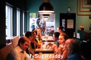 Libros para aprender a ligar: Un restaurante lleno de personas hablando. Un lugar muy sociable, donde se hacen nuevos amigos y relaciones. Gente atractiva es muy sociable y se encuentran en lugares como este. 